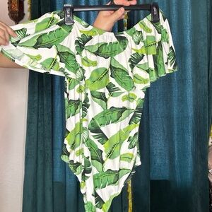 Buttery soft off the shoulder tropical bodysuit.